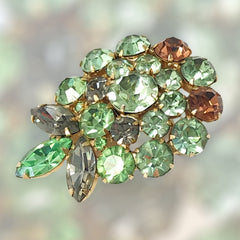 Vintage Weiss green and smoked topaz rhinestone teardrop brooch with gold‑tone setting.