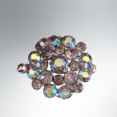 Vintage 1950s Weiss round brooch with light amethyst and amethyst AB rhinestones arranged in a layered cluster, set in rhodium‑plated metal with a dangling bead accent