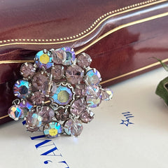 Vintage 1950s Weiss round brooch with light amethyst and amethyst AB rhinestones arranged in a layered cluster, set in rhodium‑plated metal with a dangling bead accent