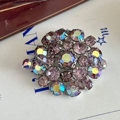 Vintage 1950s Weiss round brooch with light amethyst and amethyst AB rhinestones arranged in a layered cluster, set in rhodium‑plated metal with a dangling bead accent