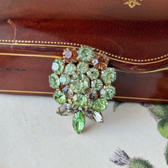 Vintage Weiss green and smoked topaz rhinestone teardrop brooch with gold‑tone setting.