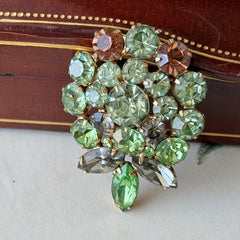Vintage Weiss green and smoked topaz rhinestone teardrop brooch with gold‑tone setting.