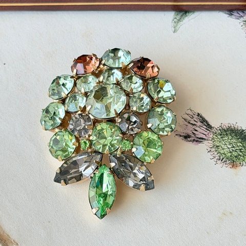 Vintage Weiss green and smoked topaz rhinestone teardrop brooch with gold‑tone setting.