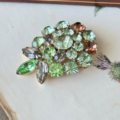 Vintage Weiss green and smoked topaz rhinestone teardrop brooch with gold‑tone setting.