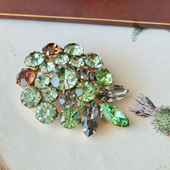 Vintage Weiss green and smoked topaz rhinestone teardrop brooch with gold‑tone setting.
