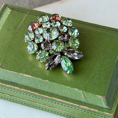 Vintage Weiss green and smoked topaz rhinestone teardrop brooch with gold‑tone setting.