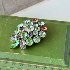 Vintage Weiss green and smoked topaz rhinestone teardrop brooch with gold‑tone setting.
