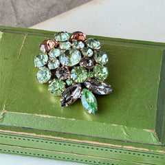 Vintage Weiss green and smoked topaz rhinestone teardrop brooch with gold‑tone setting.