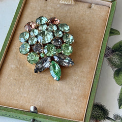 Vintage Weiss green and smoked topaz rhinestone teardrop brooch with gold‑tone setting.