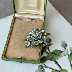 Vintage Weiss green and smoked topaz rhinestone teardrop brooch with gold‑tone setting.