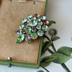 Vintage Weiss green and smoked topaz rhinestone teardrop brooch with gold‑tone setting.