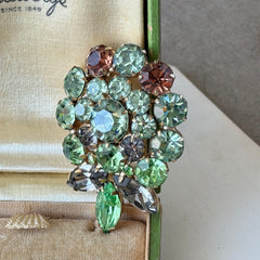 Vintage Weiss green and smoked topaz rhinestone teardrop brooch with gold‑tone setting.