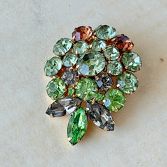 Vintage Weiss green and smoked topaz rhinestone teardrop brooch with gold‑tone setting.