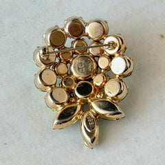 Vintage Weiss green and smoked topaz rhinestone teardrop brooch with gold‑tone setting.