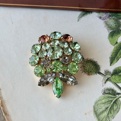 Vintage Weiss green and smoked topaz rhinestone teardrop brooch with gold‑tone setting.