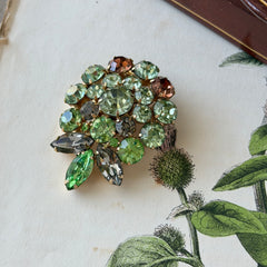 Vintage Weiss green and smoked topaz rhinestone teardrop brooch with gold‑tone setting.