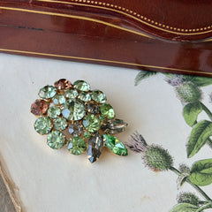 Vintage Weiss green and smoked topaz rhinestone teardrop brooch with gold‑tone setting.