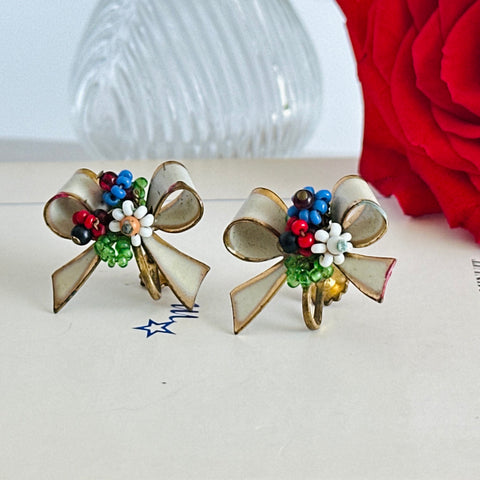 Signed vintage Coro screw-back earrings with white enamel bows and multicolor wired seed bead flowers, 1940s–50s