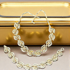 Vintage 1950s white enamel and gold-tone necklace and bracelet set with openwork textured wire design, adjustable hook clasp necklace and snap lock bracelet, in very good condition with light enamel wear.