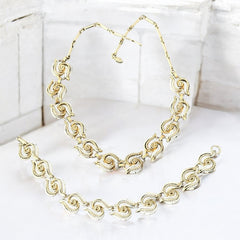 Vintage 1950s white enamel and gold-tone necklace and bracelet set with openwork textured wire design, adjustable hook clasp necklace and snap lock bracelet, in very good condition with light enamel wear.