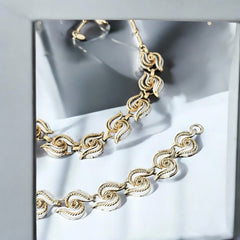 Vintage 1950s white enamel and gold-tone necklace and bracelet set with openwork textured wire design, adjustable hook clasp necklace and snap lock bracelet, in very good condition with light enamel wear.