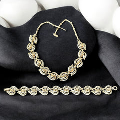 Vintage 1950s white enamel and gold-tone necklace and bracelet set with openwork textured wire design, adjustable hook clasp necklace and snap lock bracelet, in very good condition with light enamel wear.