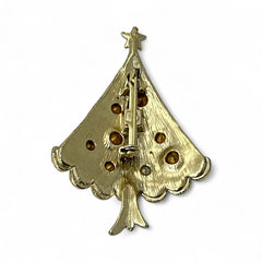 Vintage gold-tone Christmas tree brooch with multicolor rhinestones and scalloped edges, featuring a star at the top and textured detailing; back view shows pin clasp and trunk-shaped base, typical of 1980s–1990s holiday jewelry.