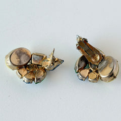 Vintage 1950s gold tone clip‑on earrings with yellow, blue, and green rhinestones in oval, pear, marquise, and emerald cuts, shown from multiple angles.