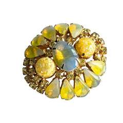 Vintage gold‑tone brooch with blue‑gray givre cabochon, yellow givre teardrops, confetti Lucite cabochons, and yellow chaton rhinestones.