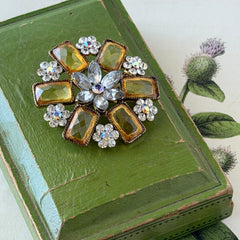 Vintage gold‑tone floral brooch with yellow emerald‑cut rhinestones and clear AB rhinestone clusters.