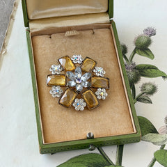 Vintage gold‑tone floral brooch with yellow emerald‑cut rhinestones and clear AB rhinestone clusters.