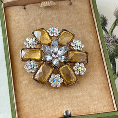 Vintage gold‑tone floral brooch with yellow emerald‑cut rhinestones and clear AB rhinestone clusters.