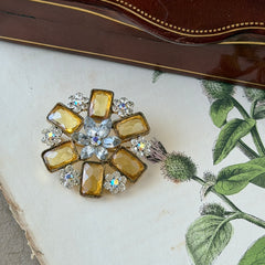 Vintage gold‑tone floral brooch with yellow emerald‑cut rhinestones and clear AB rhinestone clusters.