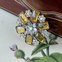 Vintage gold‑tone floral brooch with yellow emerald‑cut rhinestones and clear AB rhinestone clusters.