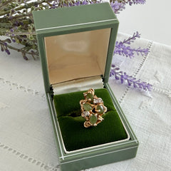 Vintage 1980s gold ring with jade oval cabochons and clear rhinestones in an organic sculptural setting, shown from multiple angles.