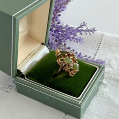 Vintage 1980s gold ring with jade oval cabochons and clear rhinestones in an organic sculptural setting, shown from multiple angles.