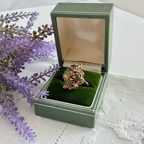 Vintage 1980s gold ring with jade oval cabochons and clear rhinestones in an organic sculptural setting, shown from multiple angles.