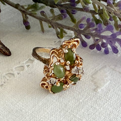 Vintage 1980s gold ring with jade oval cabochons and clear rhinestones in an organic sculptural setting, shown from multiple angles.
