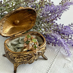 Vintage 1980s gold ring with jade oval cabochons and clear rhinestones in an organic sculptural setting, shown from multiple angles.