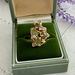 Vintage 1980s gold ring with jade oval cabochons and clear rhinestones in an organic sculptural setting, shown from multiple angles.